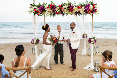 african american couple getting married by male wedding celebrant officiant