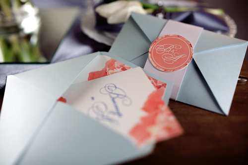 wedding invitations in envelopes on a desk